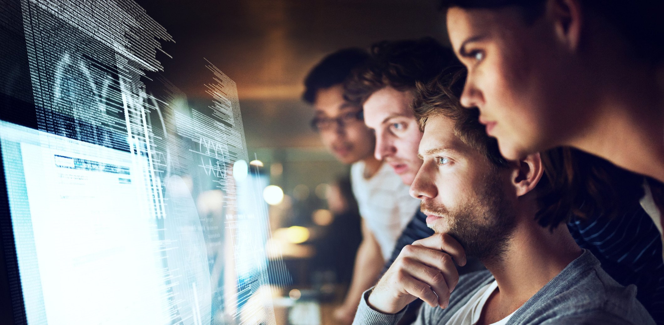 A group of people focusing on a computer screen.
